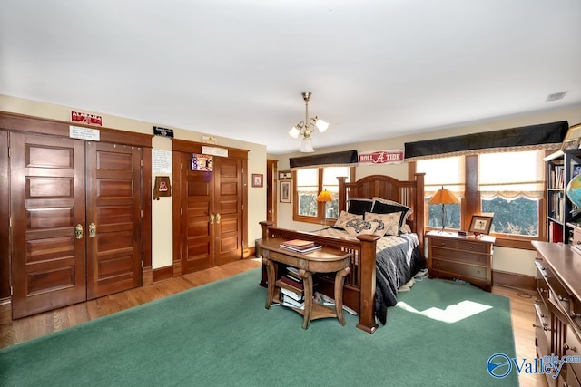 bedroom featuring multiple windows and hardwood / wood-style floors
