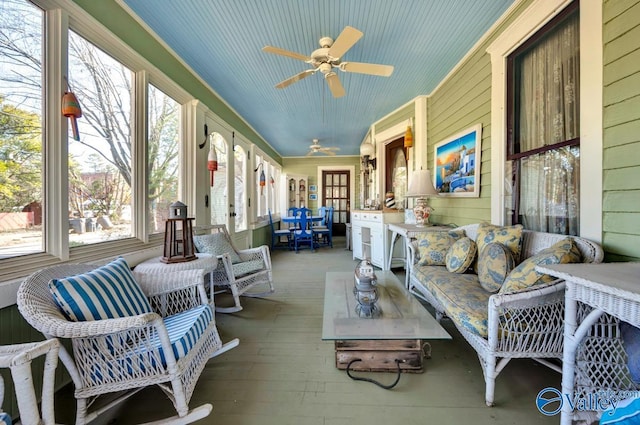 sunroom / solarium featuring ceiling fan