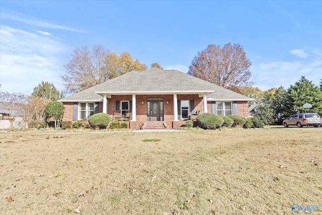 view of front of home featuring covered porch and a front yard