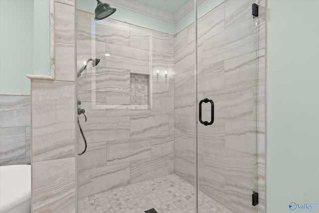 bathroom with ornamental molding and walk in shower