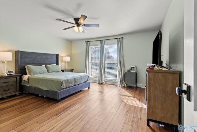 bedroom with light hardwood / wood-style floors and ceiling fan