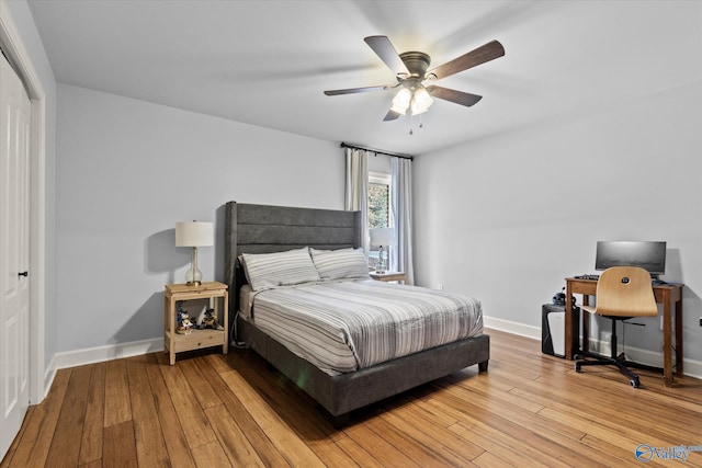 bedroom with ceiling fan, light wood-type flooring, and a closet