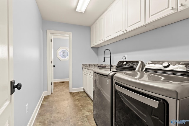 laundry area with cabinets and independent washer and dryer