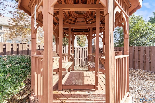 wooden terrace featuring a gazebo