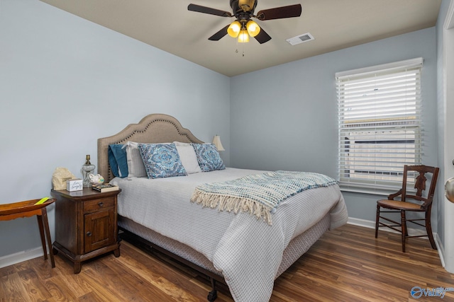 bedroom with visible vents, baseboards, ceiling fan, and wood finished floors