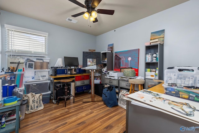 office featuring wood finished floors, ceiling fan, and visible vents