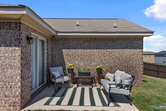 view of patio / terrace featuring outdoor lounge area and fence