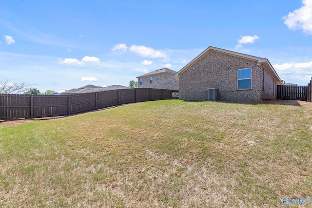 view of yard with central air condition unit and a fenced backyard