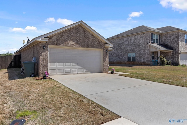 view of side of home featuring concrete driveway, brick siding, a garage, a yard, and fence