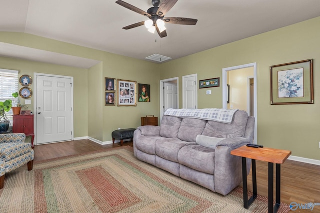 living area with wood finished floors, ceiling fan, baseboards, and visible vents