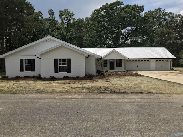 716 Ruby St, Gadsden, AL 35901 - view of front of house with a garage, driveway, and a metal roof