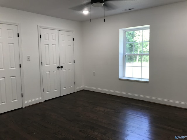 716 Ruby St, Gadsden, AL 35901 - unfurnished bedroom featuring dark wood finished floors, ceiling fan, and a closet