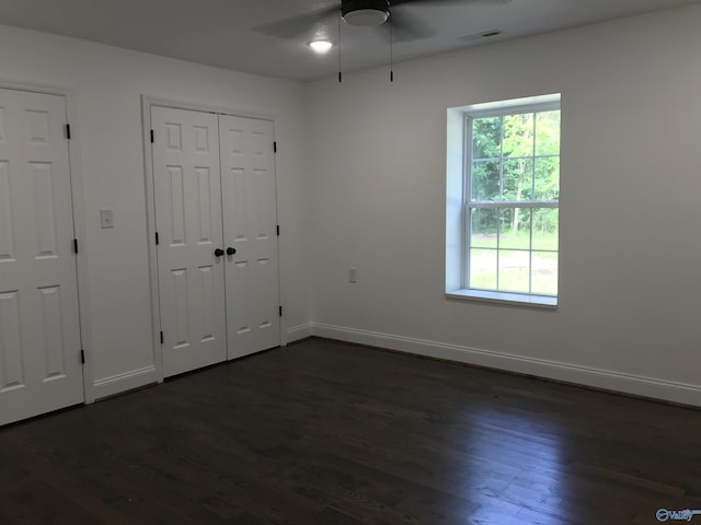 716 Ruby St, Gadsden, AL 35901 - unfurnished bedroom with dark wood-style floors, ceiling fan, and a closet