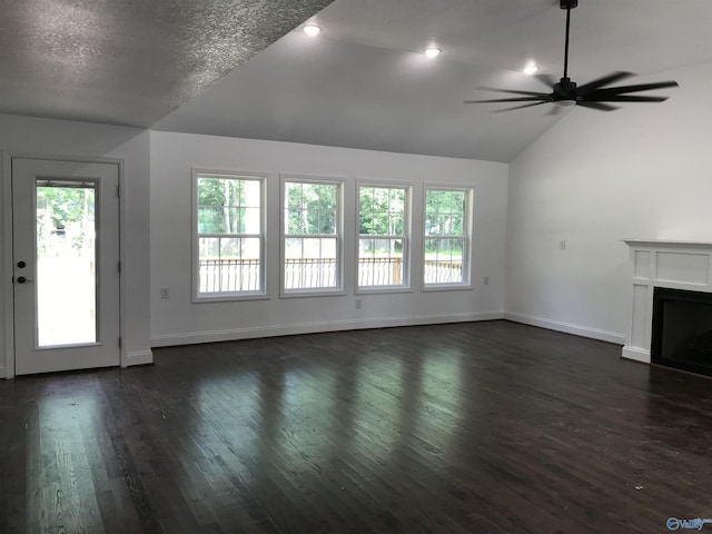 716 Ruby St, Gadsden, AL 35901 - unfurnished living room with lofted ceiling, healthy amount of natural light, a ceiling fan, dark wood-style flooring, and a fireplace