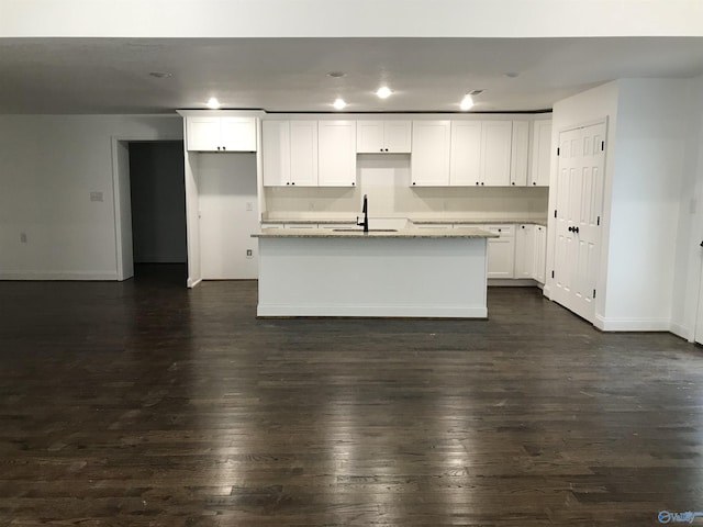 716 Ruby St, Gadsden, AL 35901 - kitchen featuring white cabinetry, a center island with sink, dark wood-style floors, light stone countertops, and recessed lighting