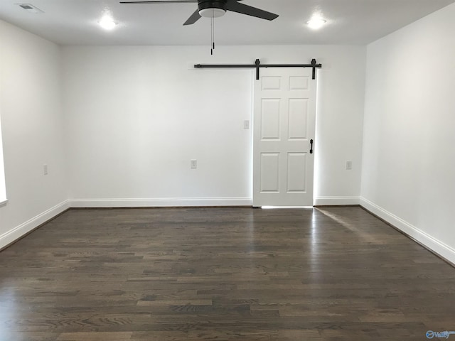 716 Ruby St, Gadsden, AL 35901 - unfurnished room with a barn door, a ceiling fan, and dark wood finished floors
