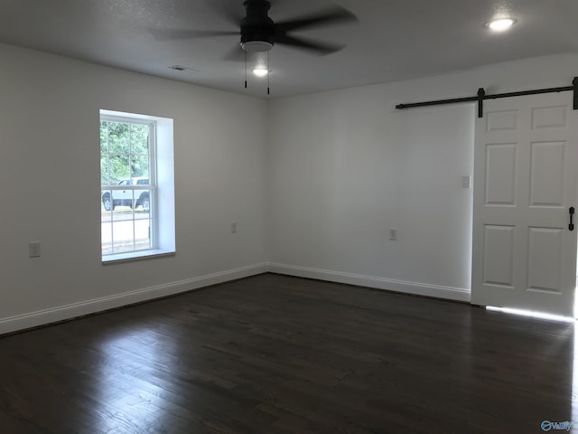 716 Ruby St, Gadsden, AL 35901 - spare room with a barn door, ceiling fan, dark wood-style floors, and recessed lighting