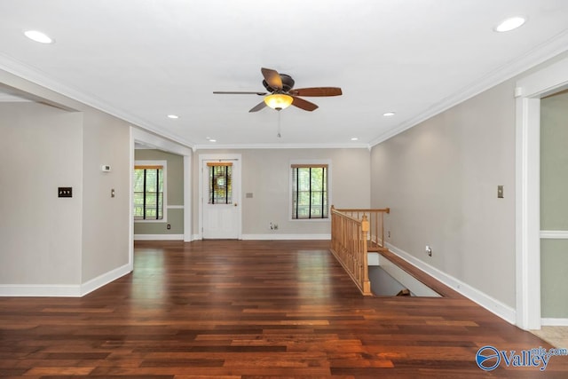 interior space featuring a ceiling fan, a wealth of natural light, baseboards, and wood finished floors