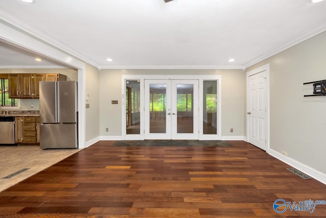 unfurnished living room with recessed lighting, french doors, a healthy amount of sunlight, and wood finished floors