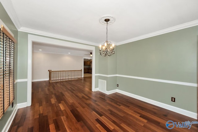 unfurnished dining area with crown molding, ceiling fan with notable chandelier, baseboards, and wood finished floors