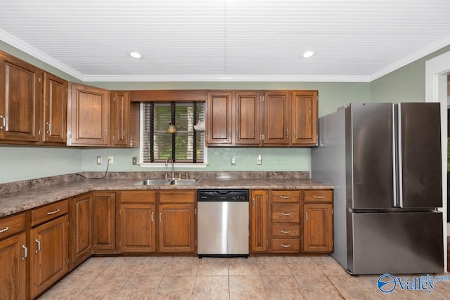 kitchen featuring brown cabinetry, stainless steel appliances, crown molding, and a sink