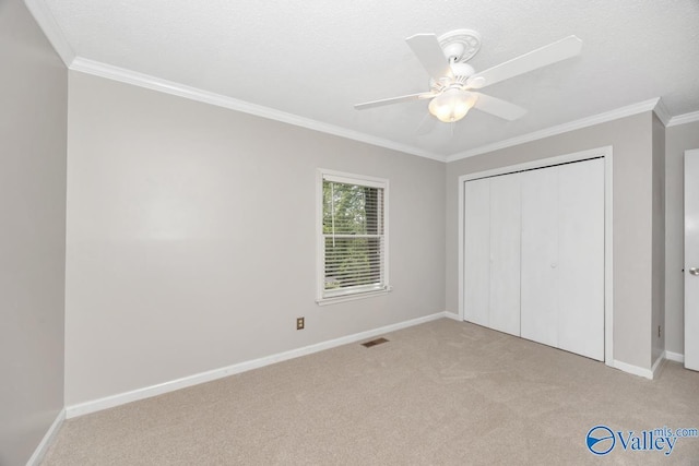 unfurnished bedroom featuring light carpet, baseboards, and ornamental molding