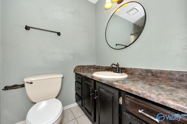bathroom with baseboards, toilet, visible vents, tile patterned flooring, and vanity