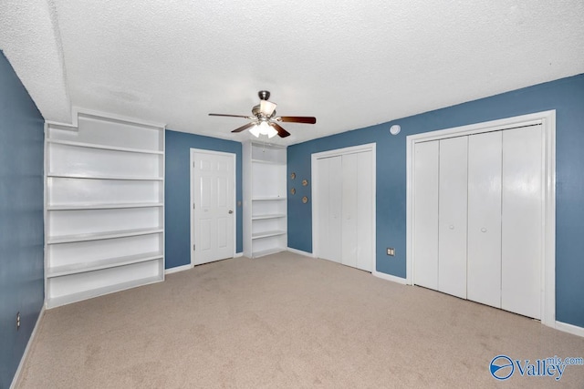 unfurnished bedroom featuring a textured ceiling, carpet flooring, and baseboards