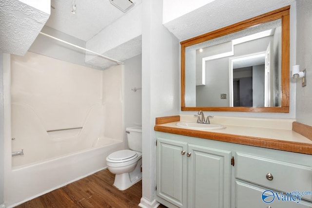 bathroom featuring toilet, wood finished floors, vanity, and shower / bath combination