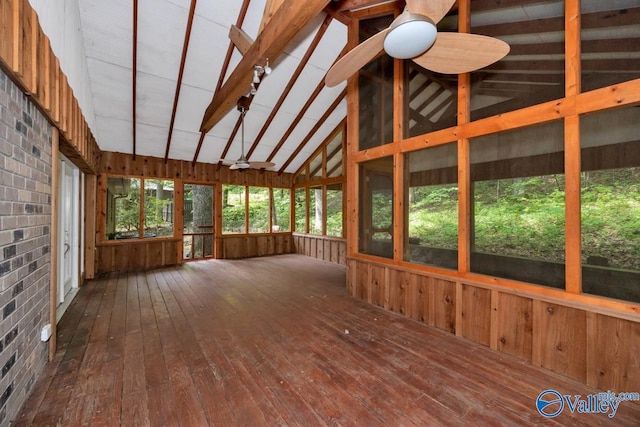 unfurnished sunroom featuring beamed ceiling