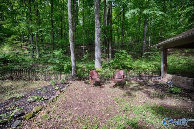 view of yard with a view of trees and fence