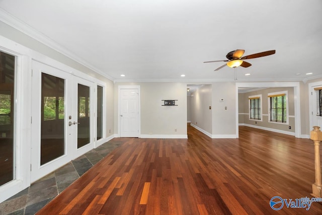 unfurnished living room with ceiling fan, french doors, baseboards, and ornamental molding