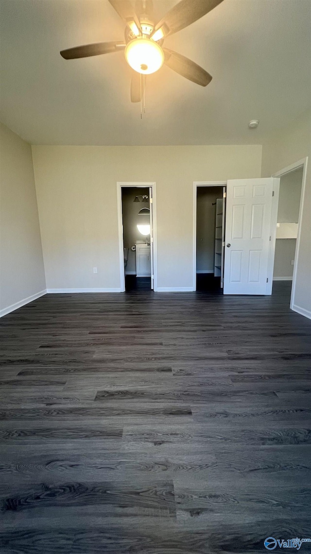 unfurnished bedroom with dark wood-style floors, a ceiling fan, and baseboards