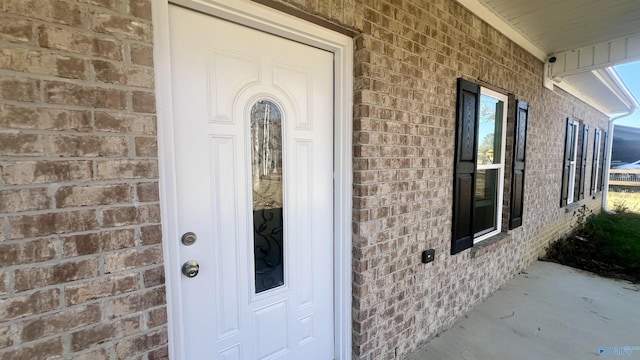 doorway to property with brick siding