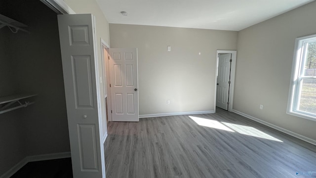 unfurnished bedroom featuring baseboards and wood finished floors