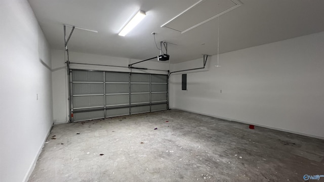 garage with a garage door opener, electric panel, and baseboards