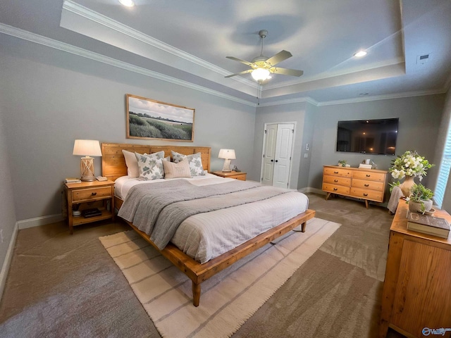 bedroom with baseboards, a raised ceiling, and carpet