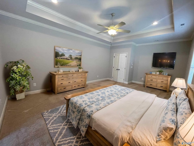 bedroom with a tray ceiling and crown molding