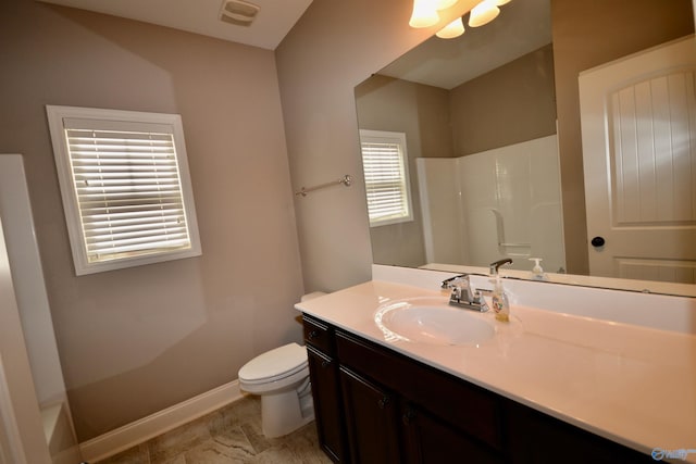 bathroom with visible vents, toilet, baseboards, walk in shower, and vanity