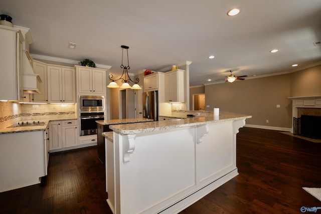 kitchen featuring a fireplace with flush hearth, ceiling fan, stainless steel appliances, dark wood-type flooring, and backsplash