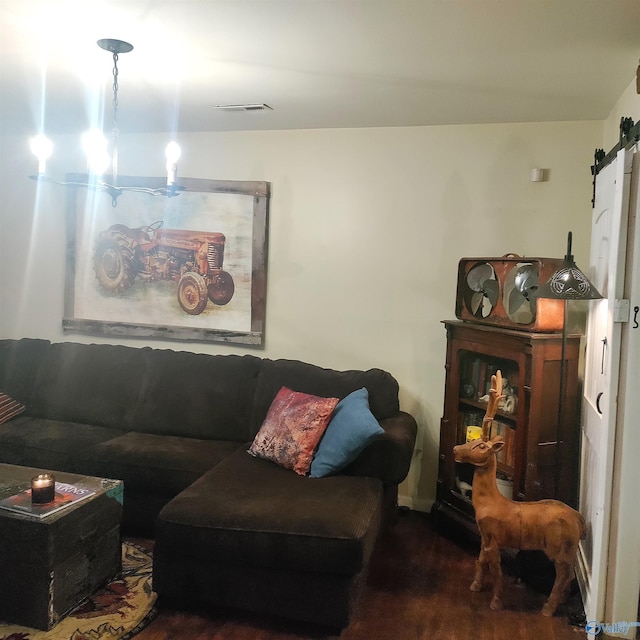 living room with wood-type flooring and a barn door