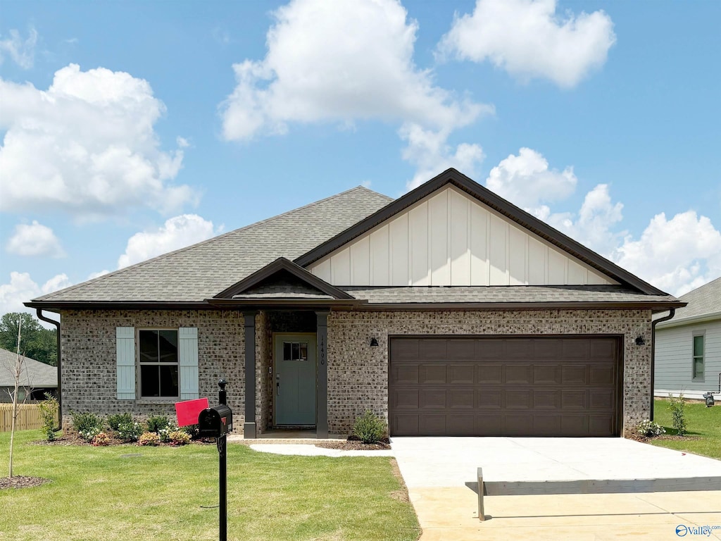 view of front of home with a front lawn and a garage