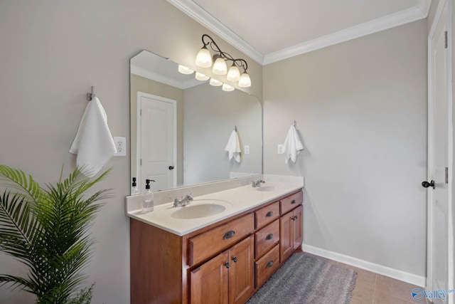 full bath featuring double vanity, crown molding, baseboards, and a sink