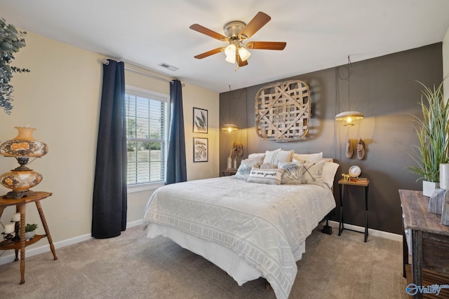 bedroom with light carpet, visible vents, and baseboards