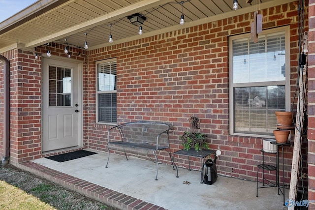 doorway to property with brick siding