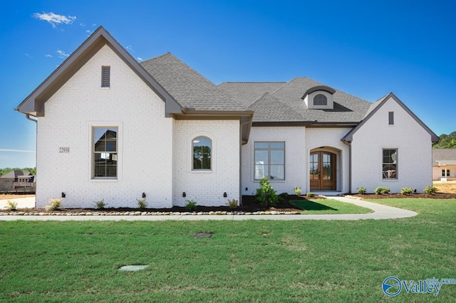 22938 Gunner Cir, Athens, AL 35613 - french provincial home with brick siding, a front yard, a shingled roof, and french doors