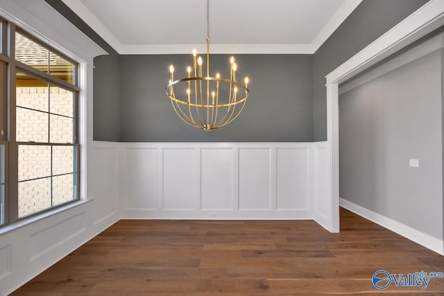 22938 Gunner Cir, Athens, AL 35613 - unfurnished dining area with a chandelier, a decorative wall, a wainscoted wall, and dark wood-type flooring