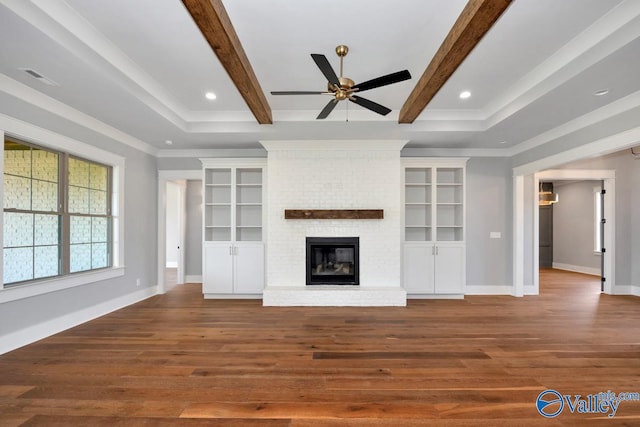 22938 Gunner Cir, Athens, AL 35613 - unfurnished living room with a ceiling fan, wood finished floors, baseboards, beam ceiling, and a brick fireplace