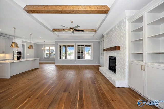 22938 Gunner Cir, Athens, AL 35613 - unfurnished living room featuring a fireplace, dark wood-style floors, ceiling fan, baseboards, and crown molding