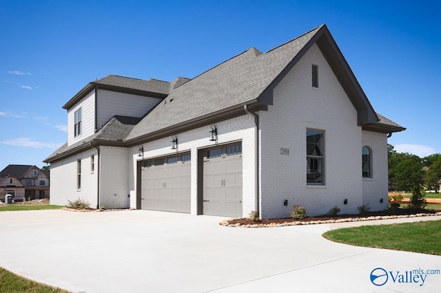 22938 Gunner Cir, Athens, AL 35613 - view of property exterior featuring brick siding, concrete driveway, an attached garage, and a shingled roof